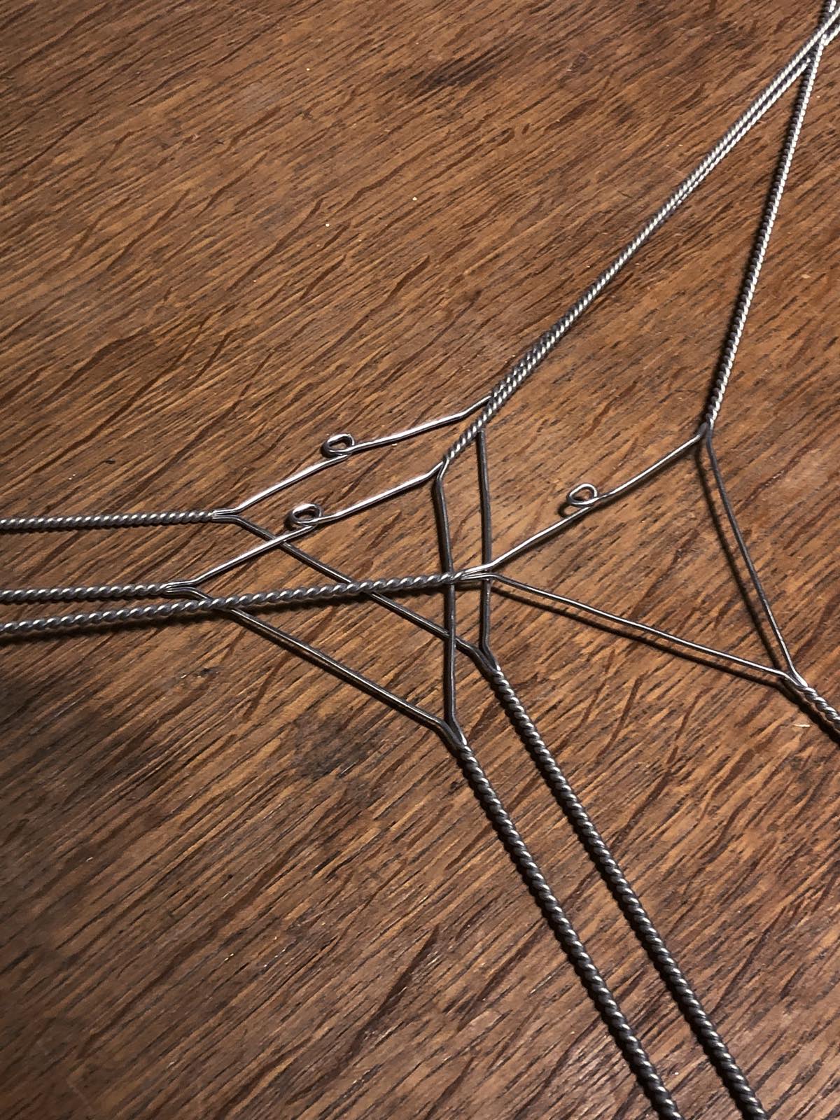 Twisted wire pieces forming a triangle with three legs